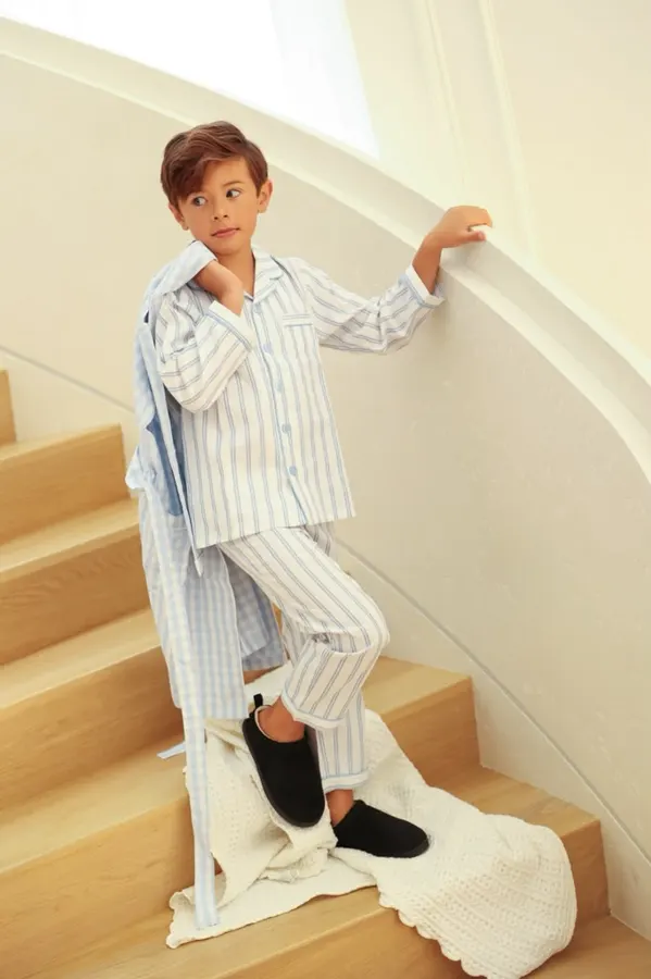 Boy in striped pajamas on a staircase, commercial photography by Photoholic, Monsey NY